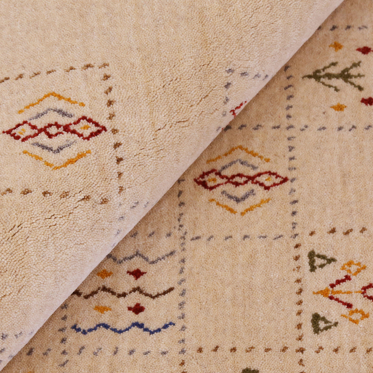 Close-up of warm beige Hand Woven Loom Lori wool rug showing dotted grid panels, diamond motifs and natural wool texture