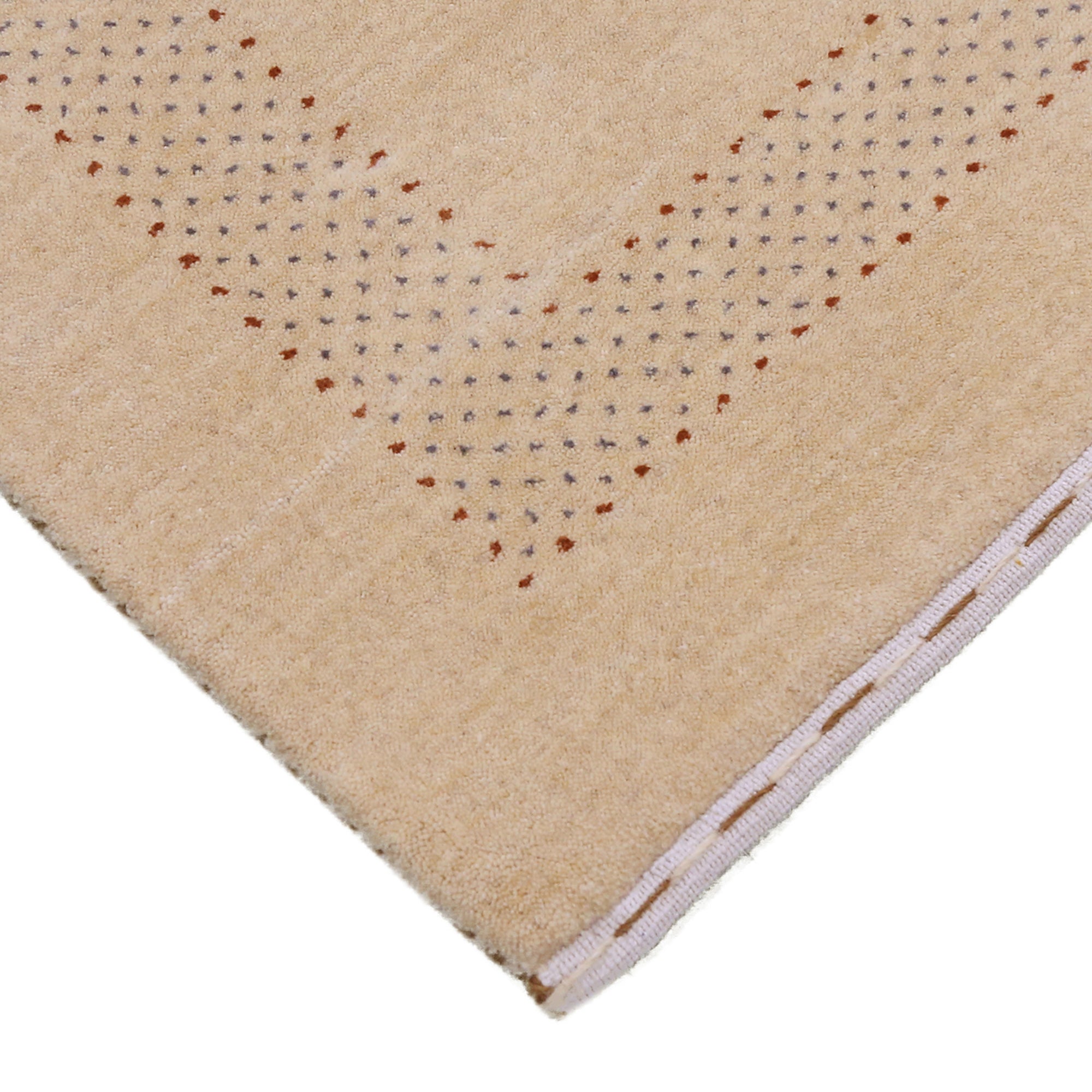 Corner and edge detail of beige Hand Woven Loom Lori wool rug showing patterned border and handcrafted finishing