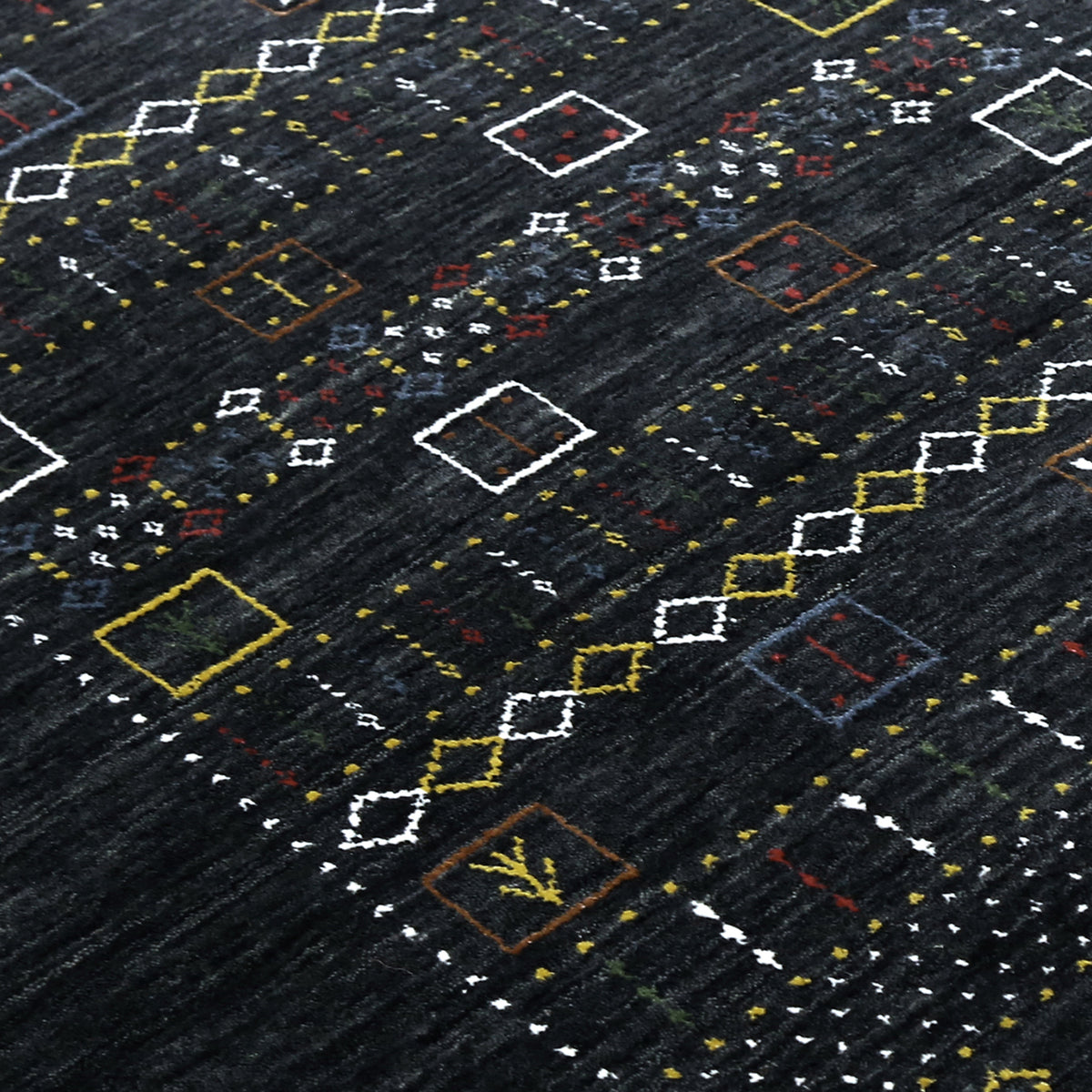 Close-up texture of black Hand Woven Loom Lori wool rug showing natural wool fibres and intricate tribal motif details
