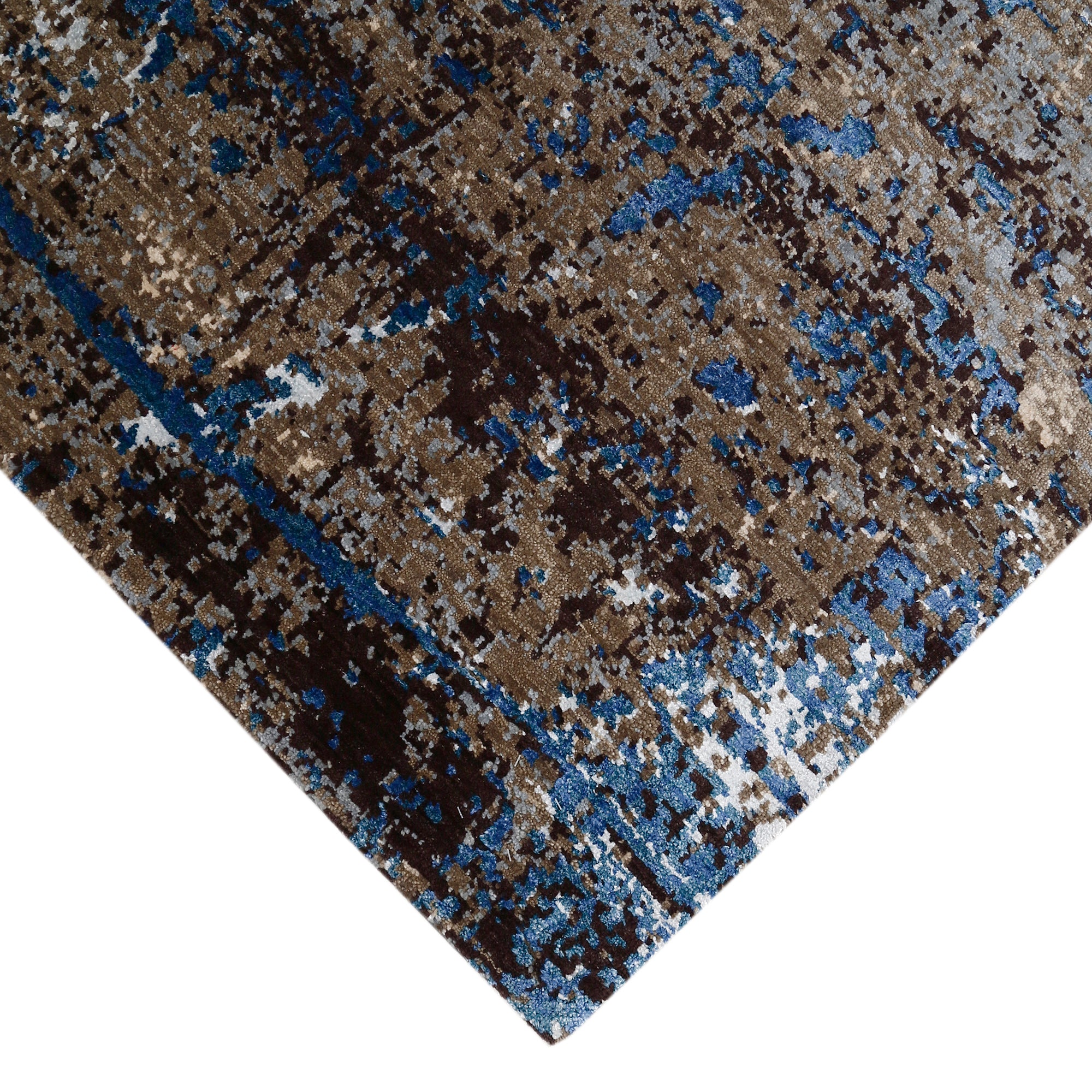 Hand-finished edge and layered distressed surface of the Blue Slate Terrain hand knotted modern rug