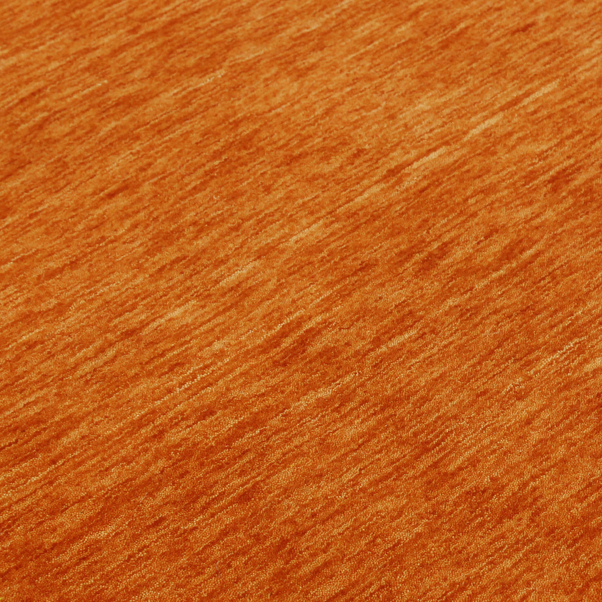 Close-up of burnt orange Hand Woven Loom Lori wool rug showing natural wool texture and detailed geometric tribal motifs