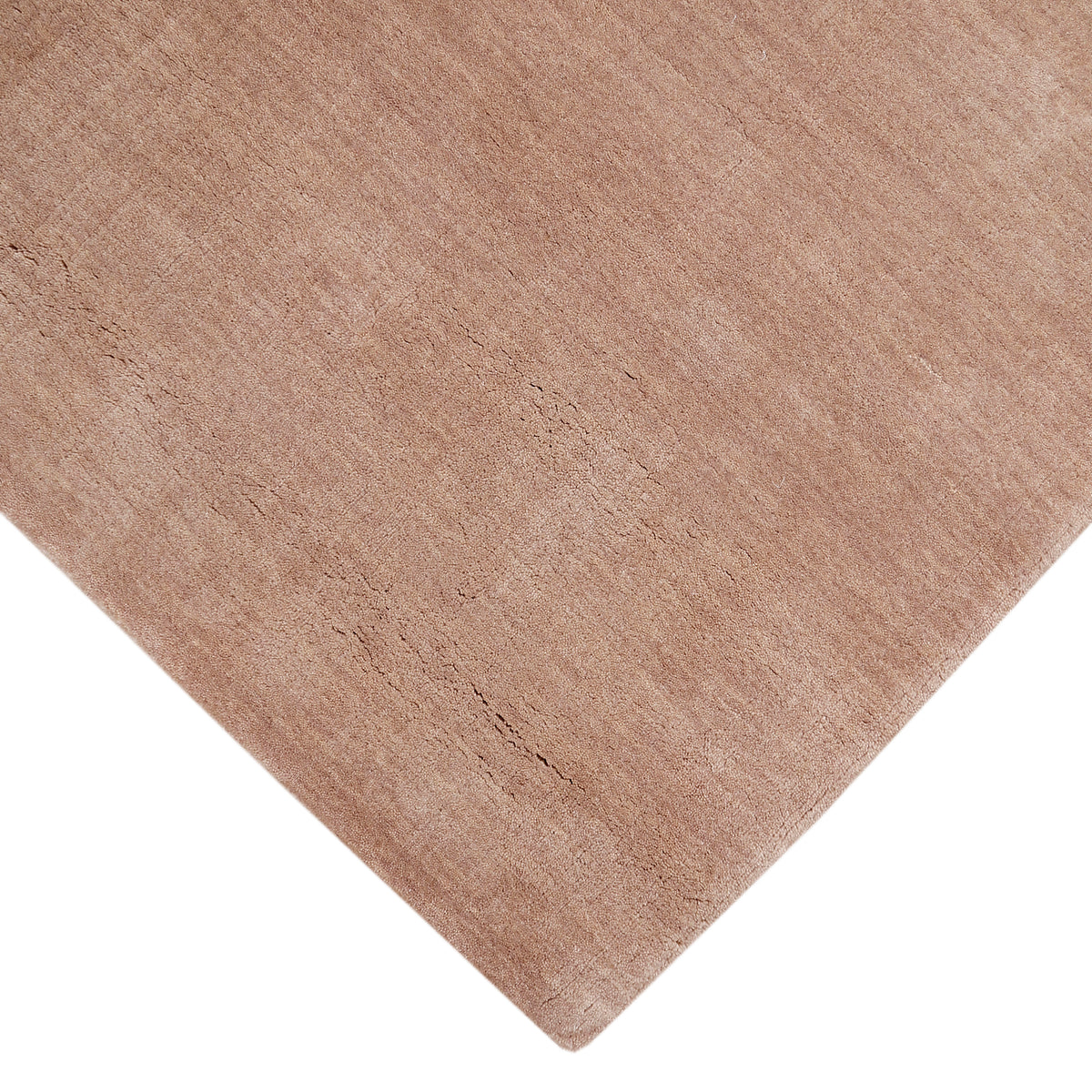 Corner and edge detail of camel hand woven Loom Lori wool rug showing its neat finishing, soft surface and plush 12–15 mm pile.