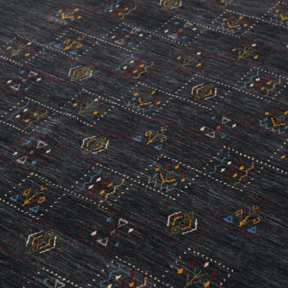 Close-up of charcoal black Hand Woven Loom Lori wool rug showing dotted tribal motif panels and natural wool texture