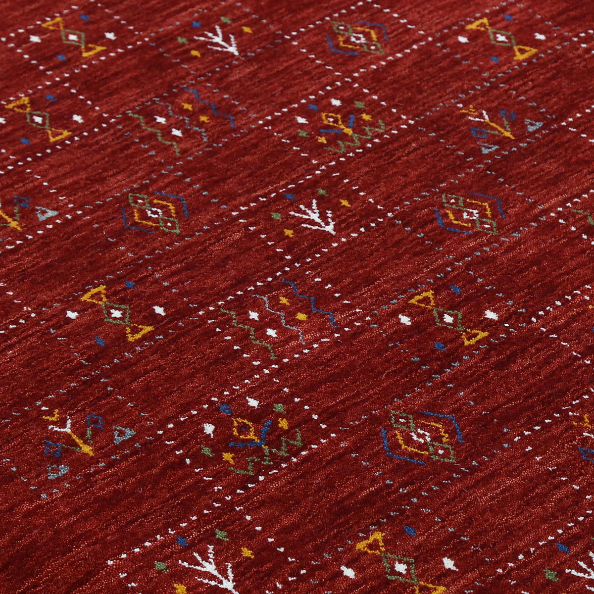 Close-up of crimson red Hand Woven Loom Lori wool rug showing dotted grid panels, diamond motifs and natural wool texture