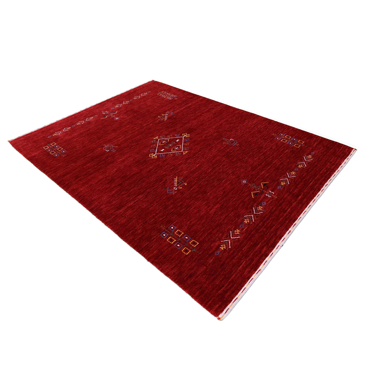 Side angle view of deep red Hand Woven Loom Lori wool rug highlighting handcrafted texture and central medallion design