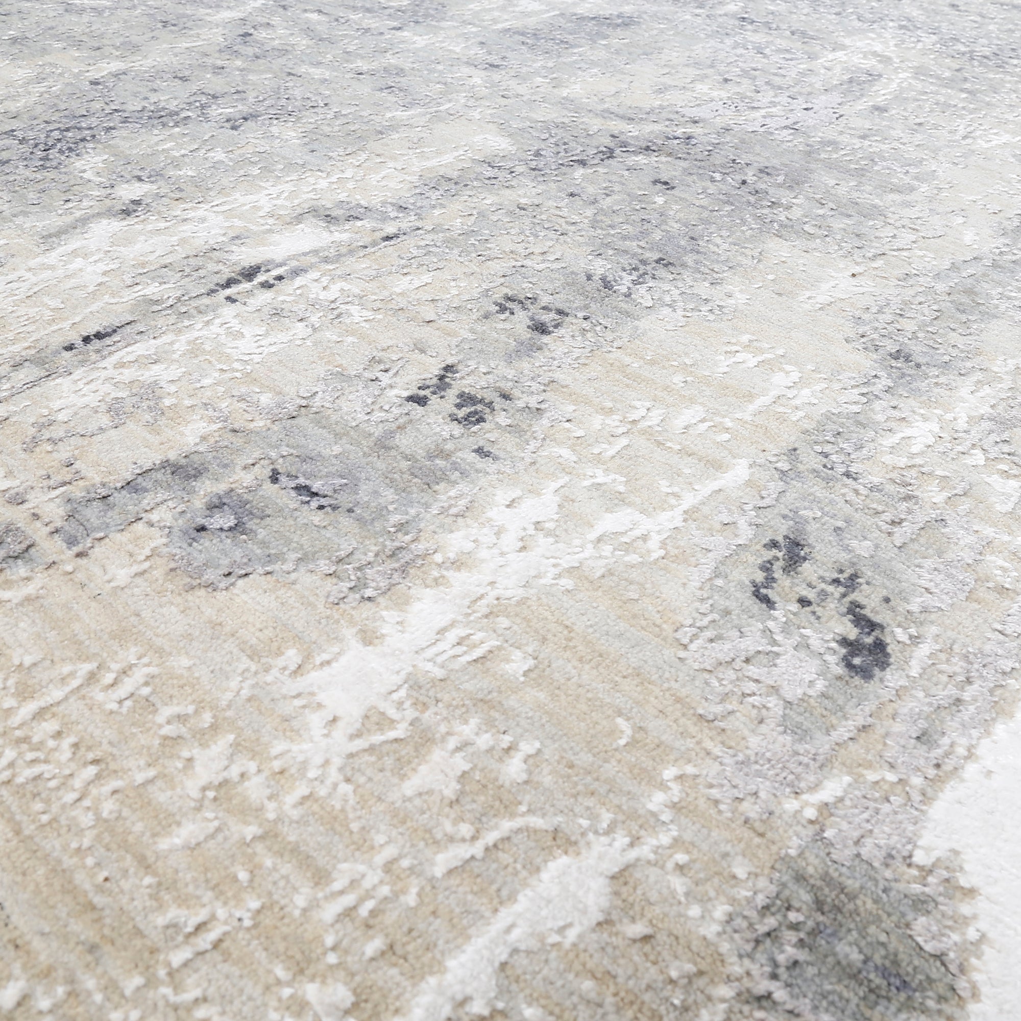 Close-up of the hand knotted wool and viscose texture with silver grey ivory beige and charcoal abstract detailing