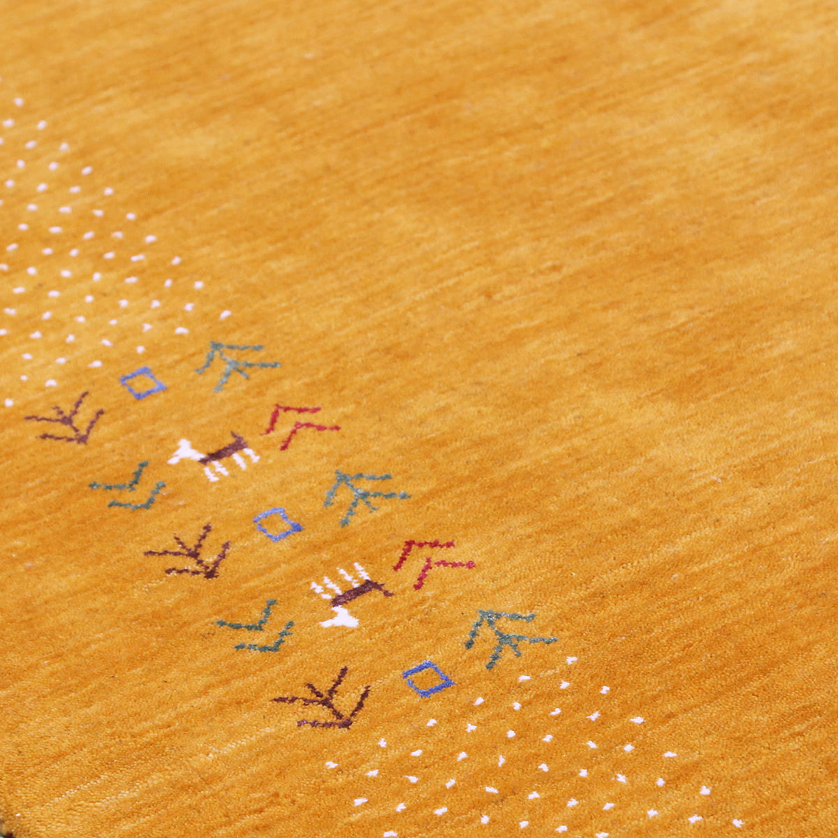 Close-up of golden mustard Hand Woven Loom Lori wool rug showing natural wool texture, botanical symbols and colourful tribal folk motifs