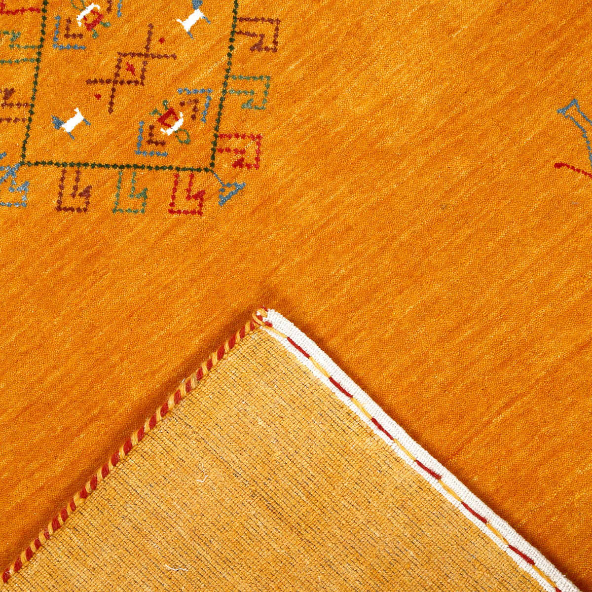 Corner and edge detail of golden ochre Hand Woven Loom Lori wool rug showing handcrafted finishing and geometric tribal detailing