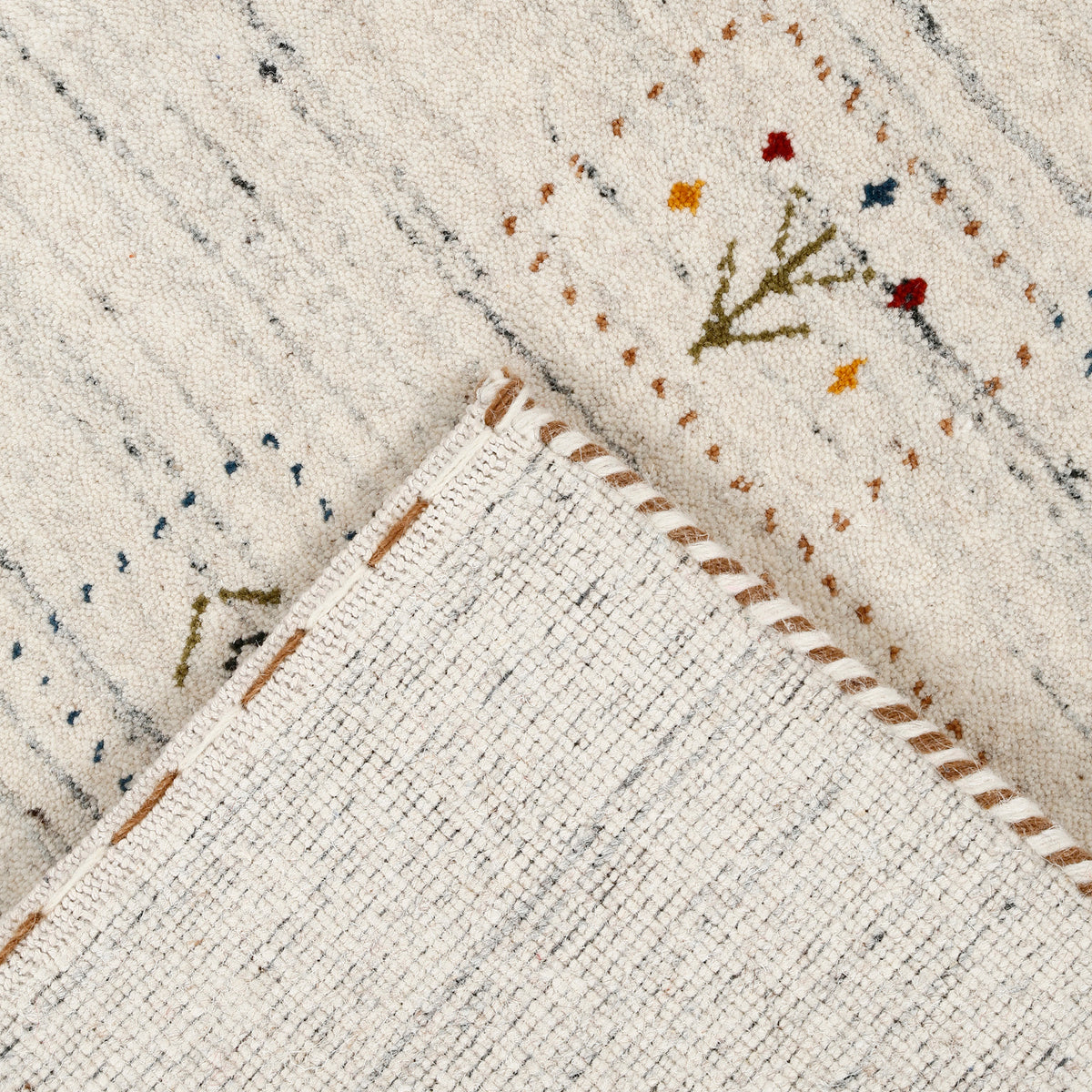 Corner and edge detail of ivory cream Hand Woven Loom Lori wool rug showing natural wool texture and handcrafted finishing