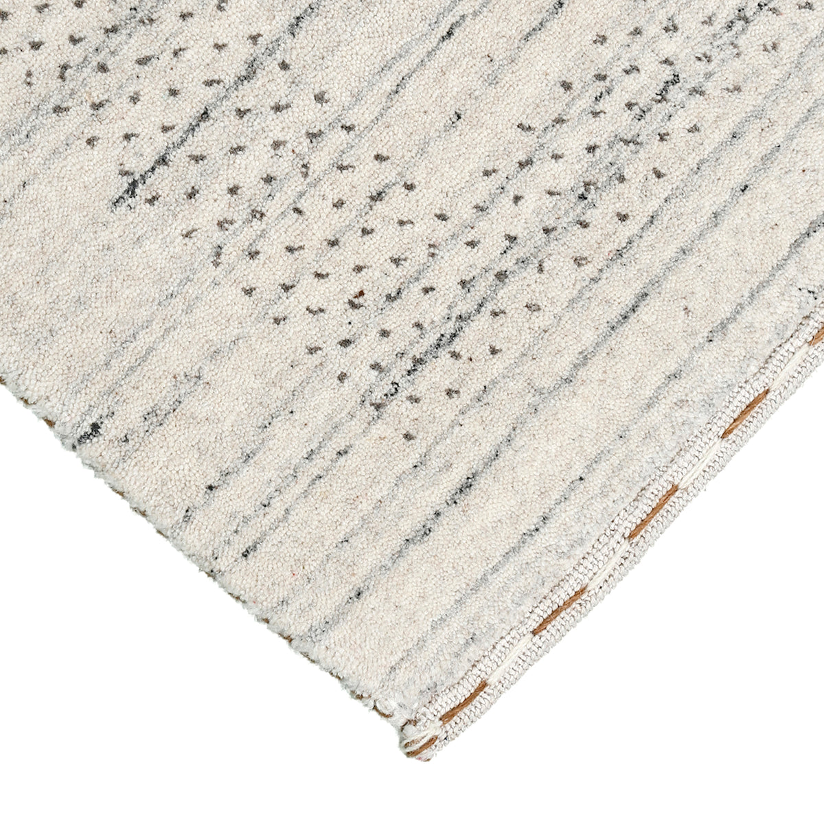 Corner and edge detail of ivory Hand Woven Loom Lori wool rug showing subtle geometric border and handcrafted finishing
