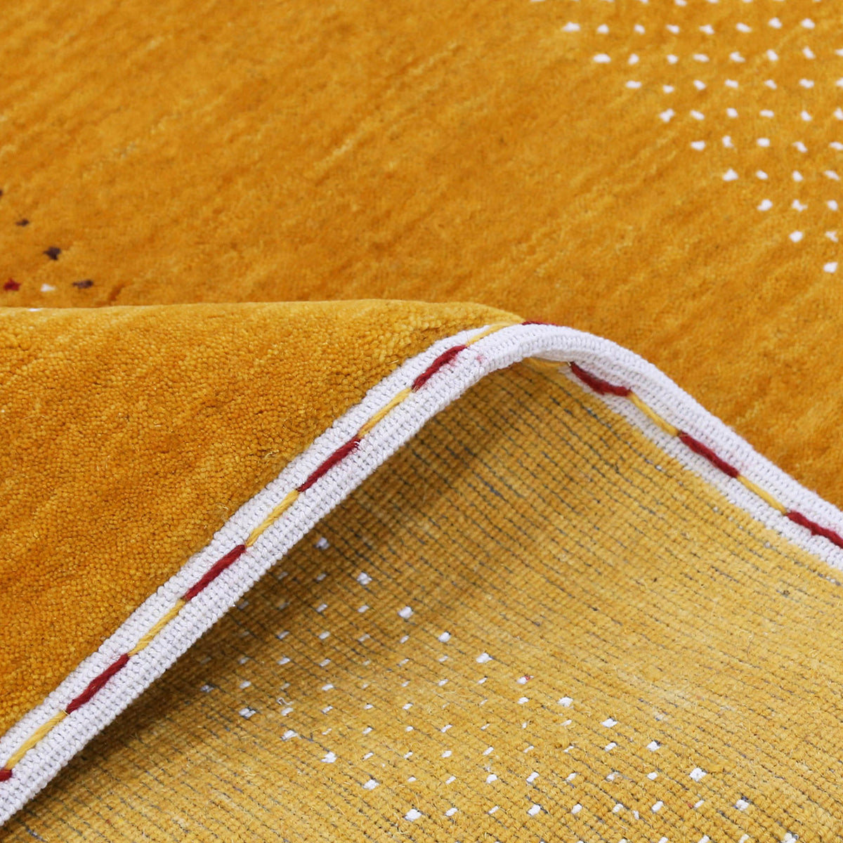 Close-up texture of mustard yellow Hand Woven Loom Lori wool rug showing natural wool fibres and intricate tribal motif detailing