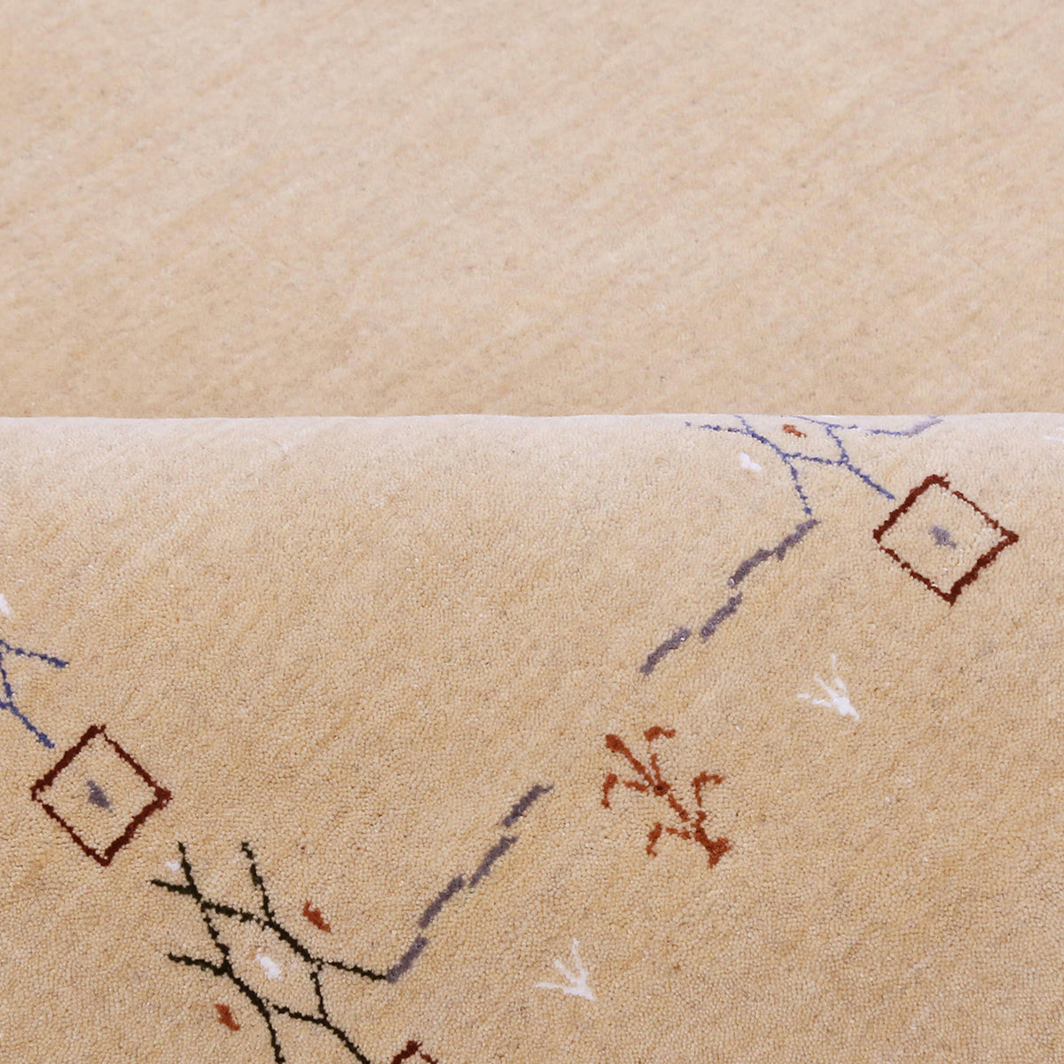Close-up of natural beige Hand Woven Loom Lori wool rug showing natural wool texture and delicate symbolic tribal motifs
