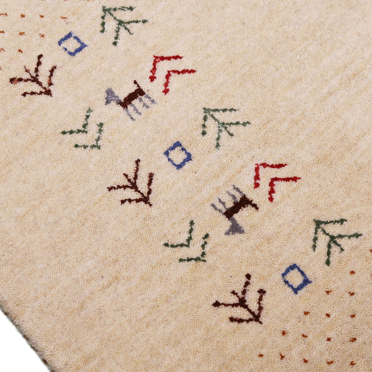 Close-up of natural beige Hand Woven Loom Lori wool rug showing natural wool texture, botanical symbols and geometric tribal motifs