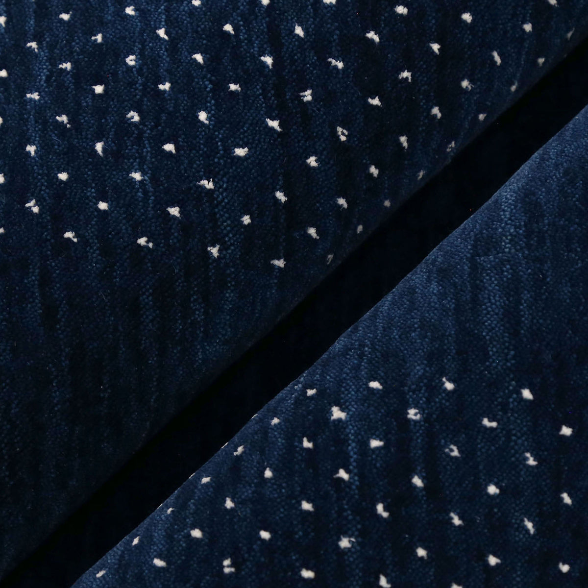 Close-up of navy blue Hand Woven Loom Lori wool rug showing natural wool texture, botanical symbols and colourful tribal motifs