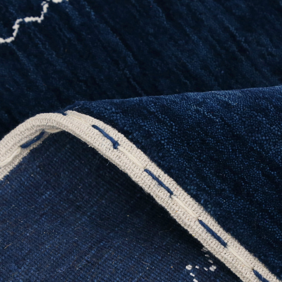 Close-up of navy blue Hand Woven Loom Lori wool rug showing natural wool texture and multicolour tribal geometric motifs