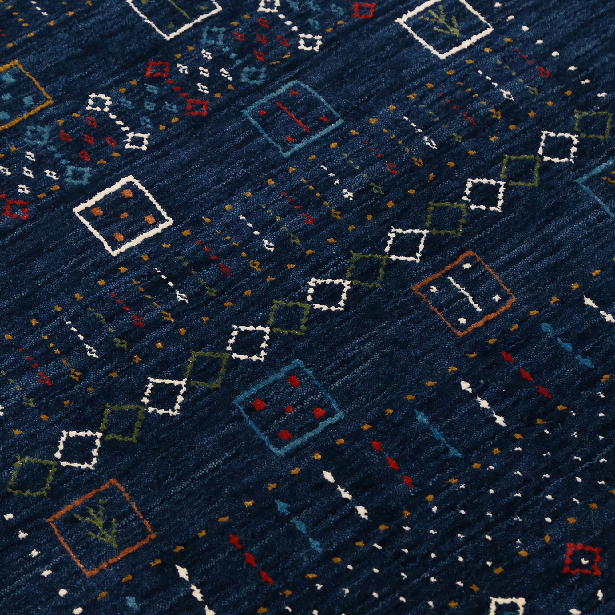 Close-up texture of navy blue Hand Woven Loom Lori wool rug showing natural wool fibres and intricate tribal motif details
