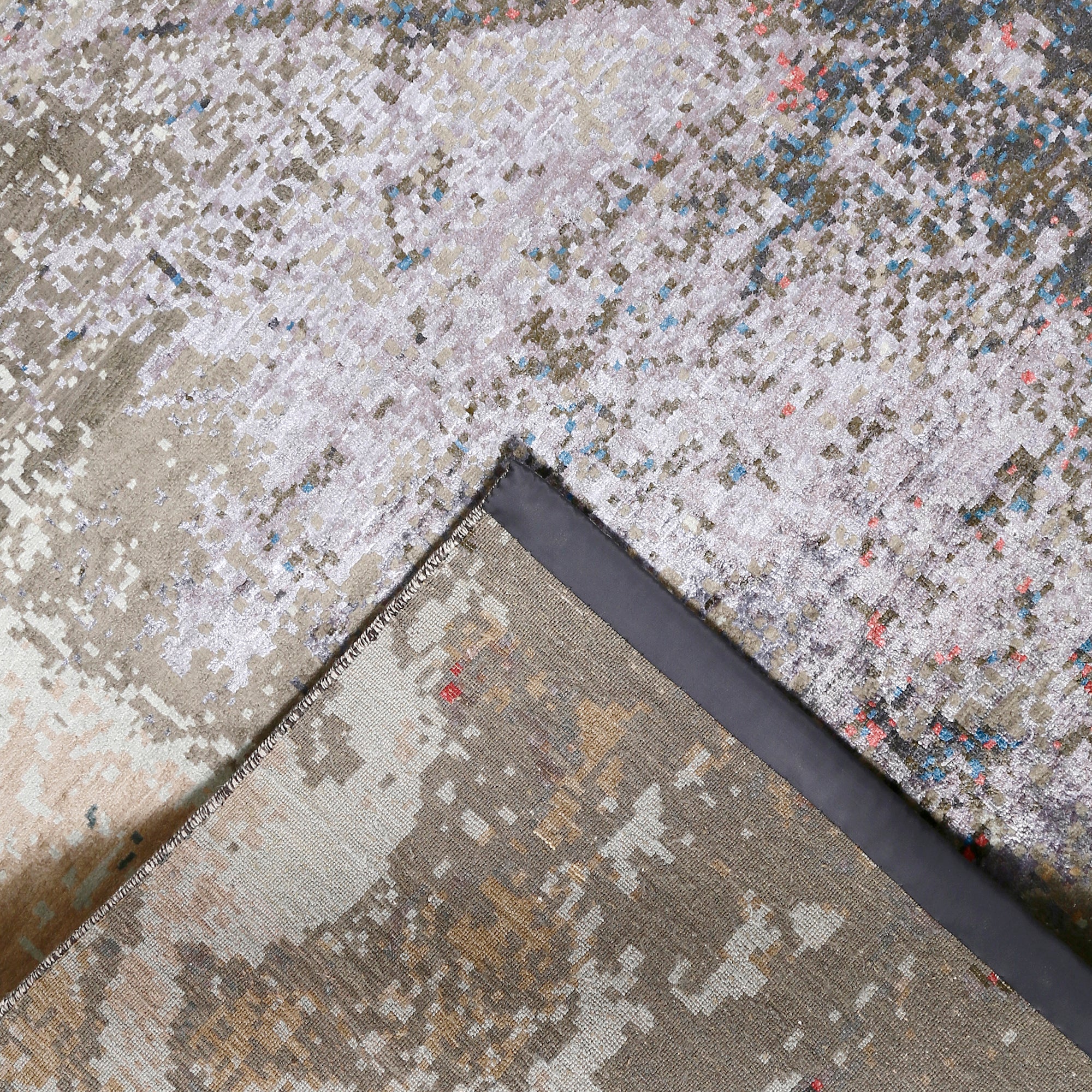 Hand-finished edge and layered abstract surface of the Noir Blush hand knotted modern rug