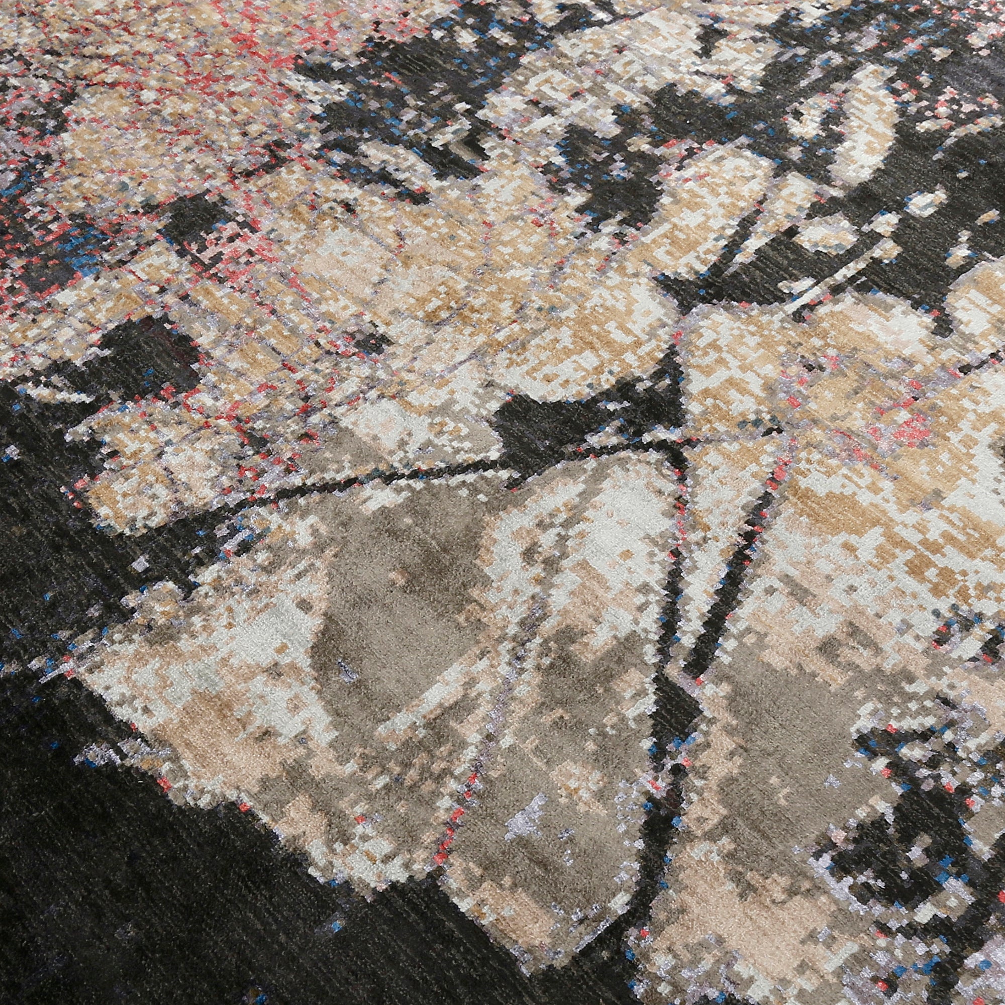 Close-up of the hand knotted wool and viscose texture with charcoal ivory beige and blush abstract detailing