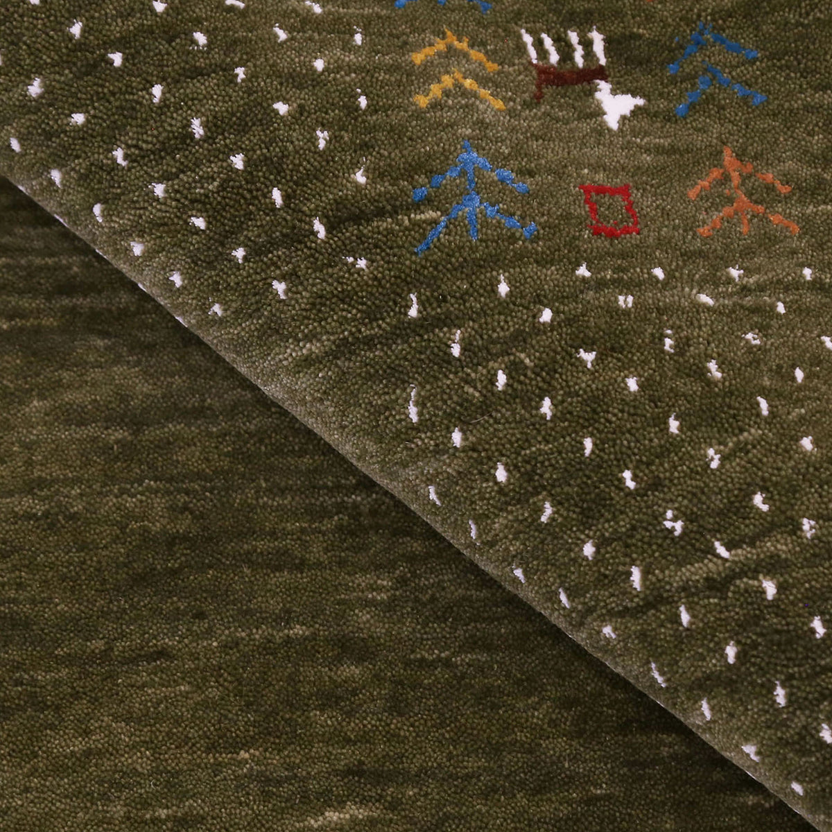 Close-up of olive green Hand Woven Loom Lori wool rug showing natural wool texture, botanical symbols and colourful tribal motifs