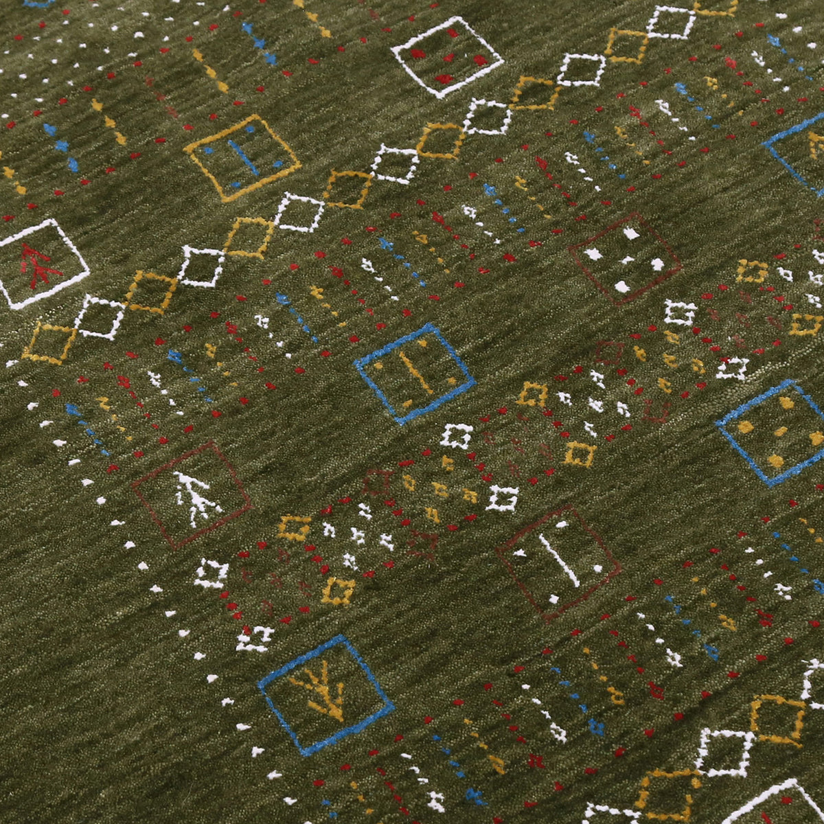 Close-up texture of Hand Woven Loom Lori wool rug showing olive green wool fibres and multicolour geometric motifs