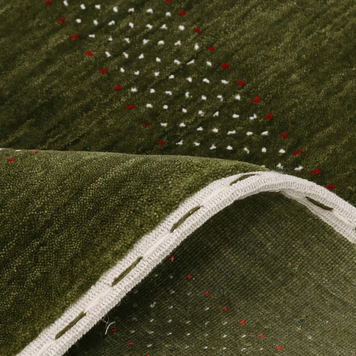 Close-up texture of Hand Woven Loom Lori wool rug showing olive green wool fibres and multicolour geometric motifs