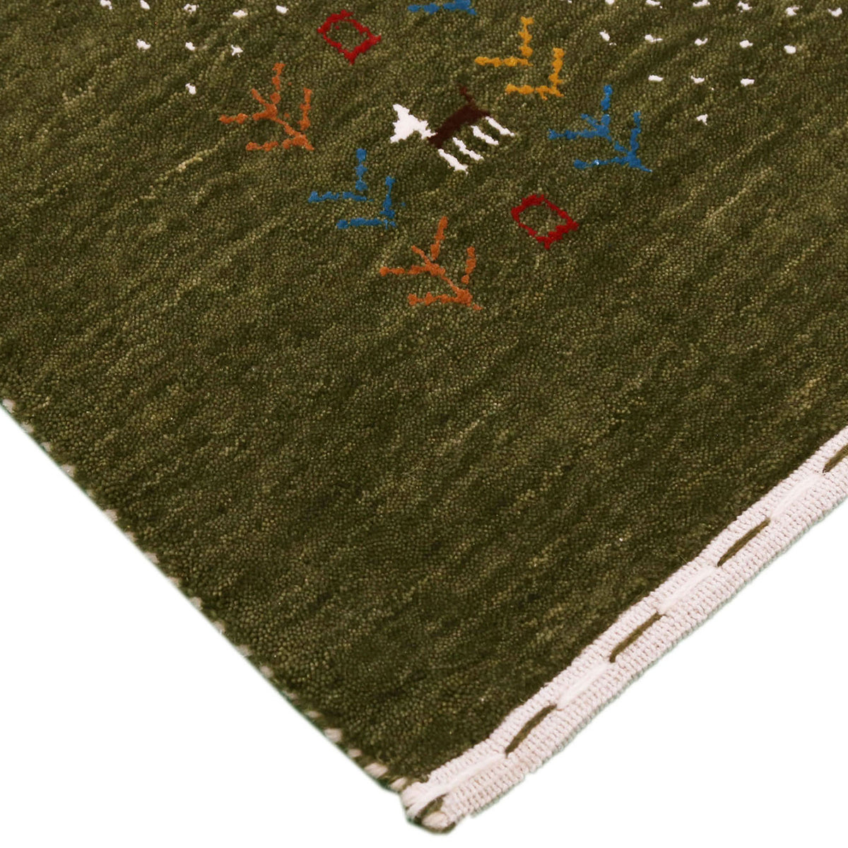 Corner and edge detail of olive green Loom Lori wool rug showing ivory dotted sections, folk motifs and handcrafted finishing