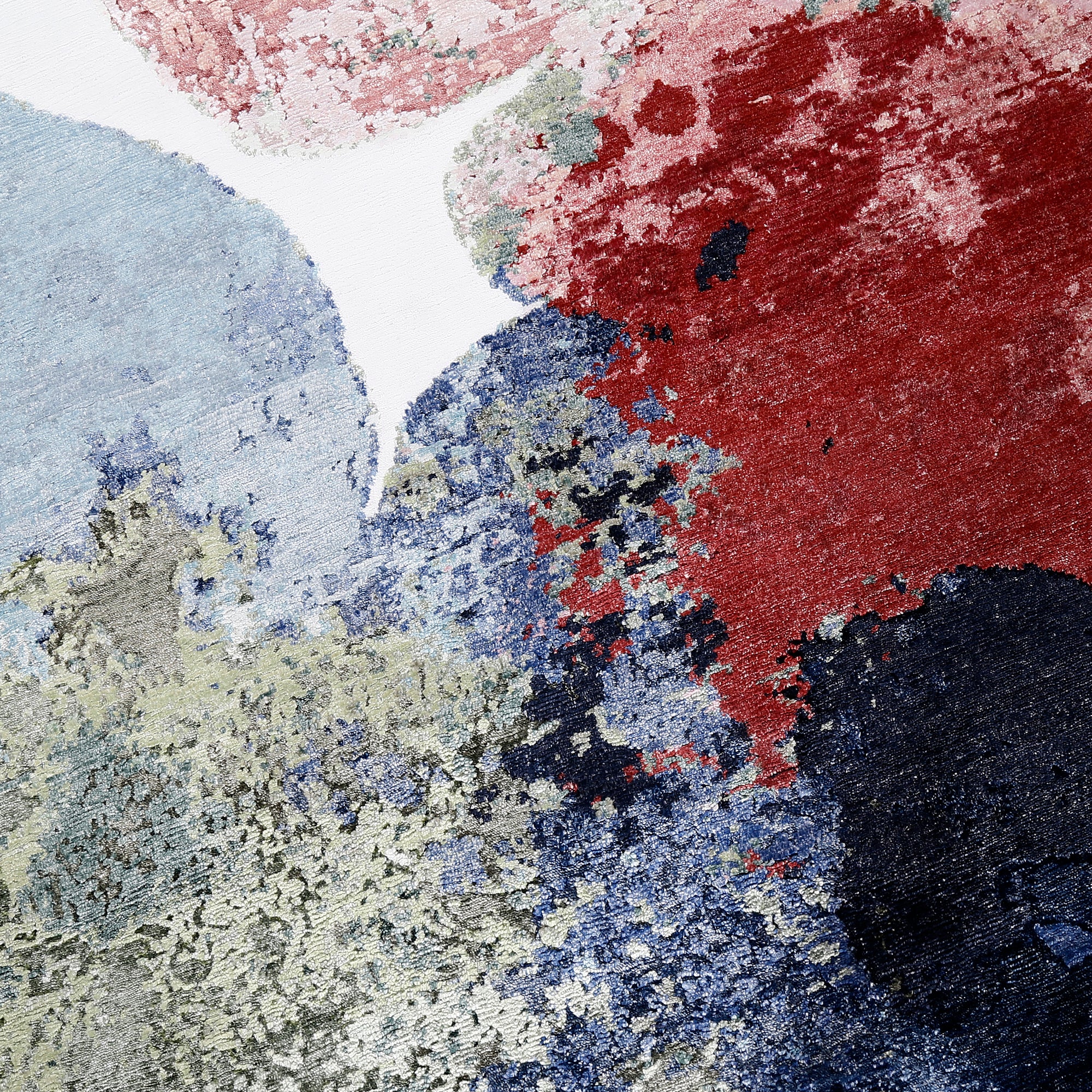 Close-up of Pastel Bloom hand knotted viscose rug with pink blue green red and navy abstract detailing