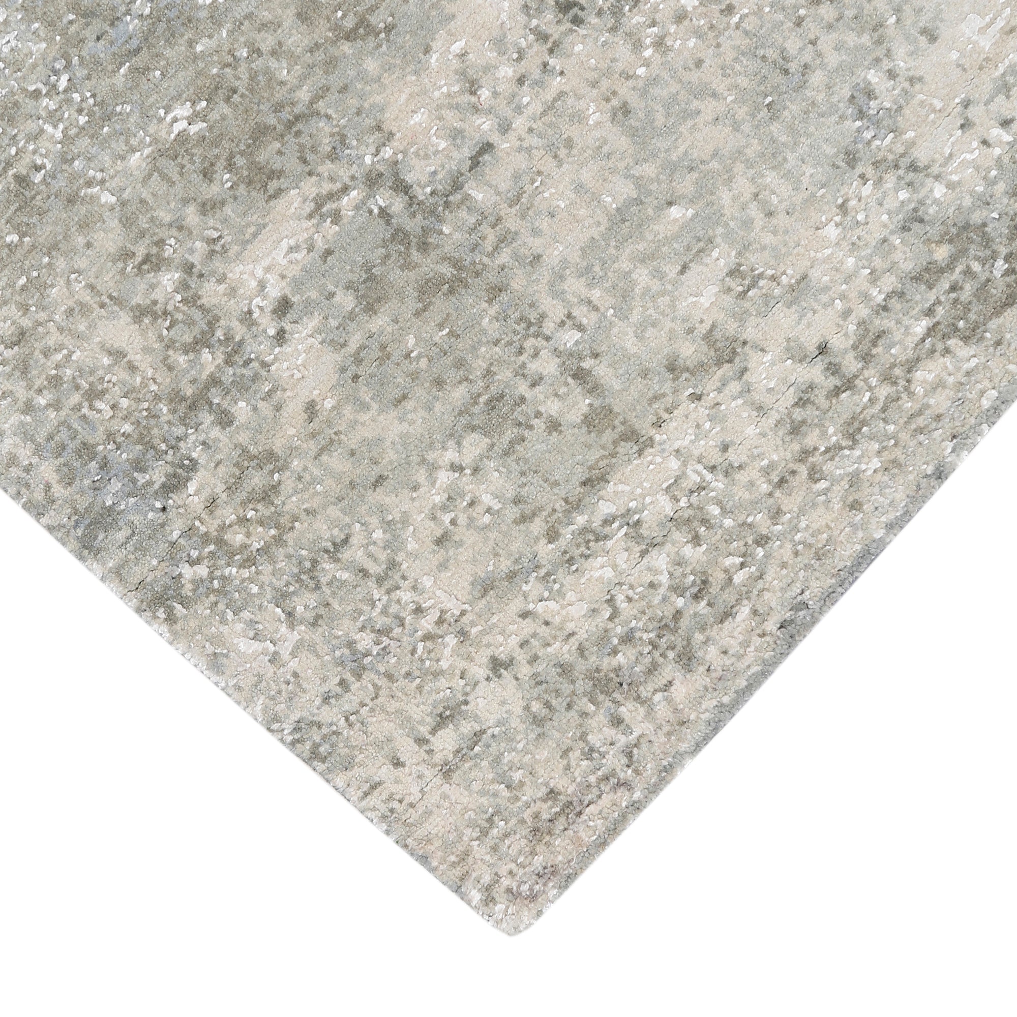 Hand-finished edge and subtle distressed detailing of the pearl mist abstract hand knotted rug