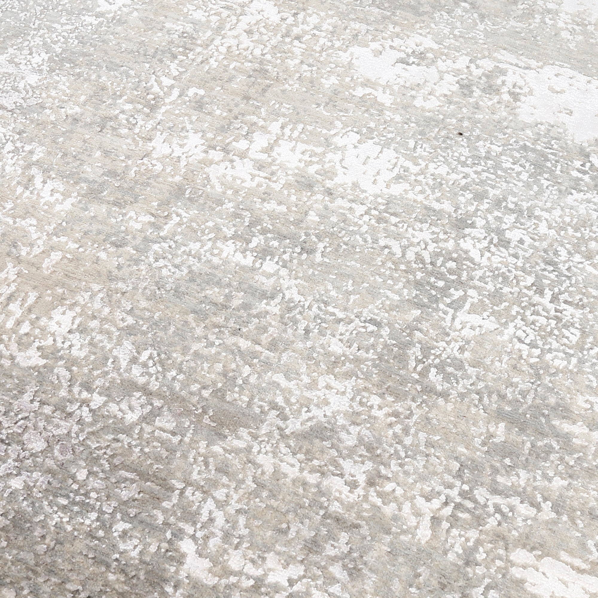 Close-up of the hand knotted wool and viscose texture with ivory beige taupe and silver grey abstract detailing
