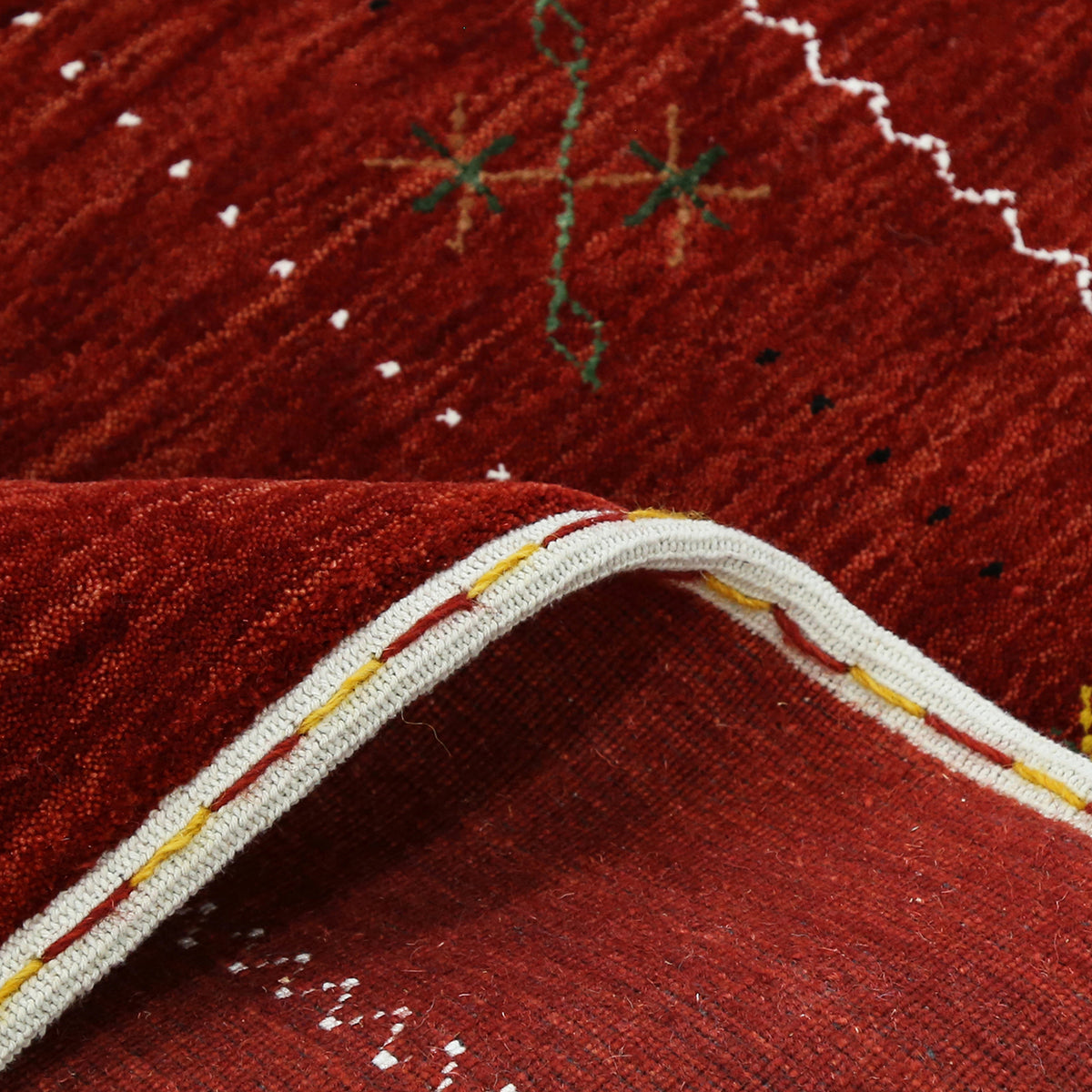 Close-up texture of red Hand Woven Loom Lori wool rug showing natural wool fibres and delicate multicolour floral detailing