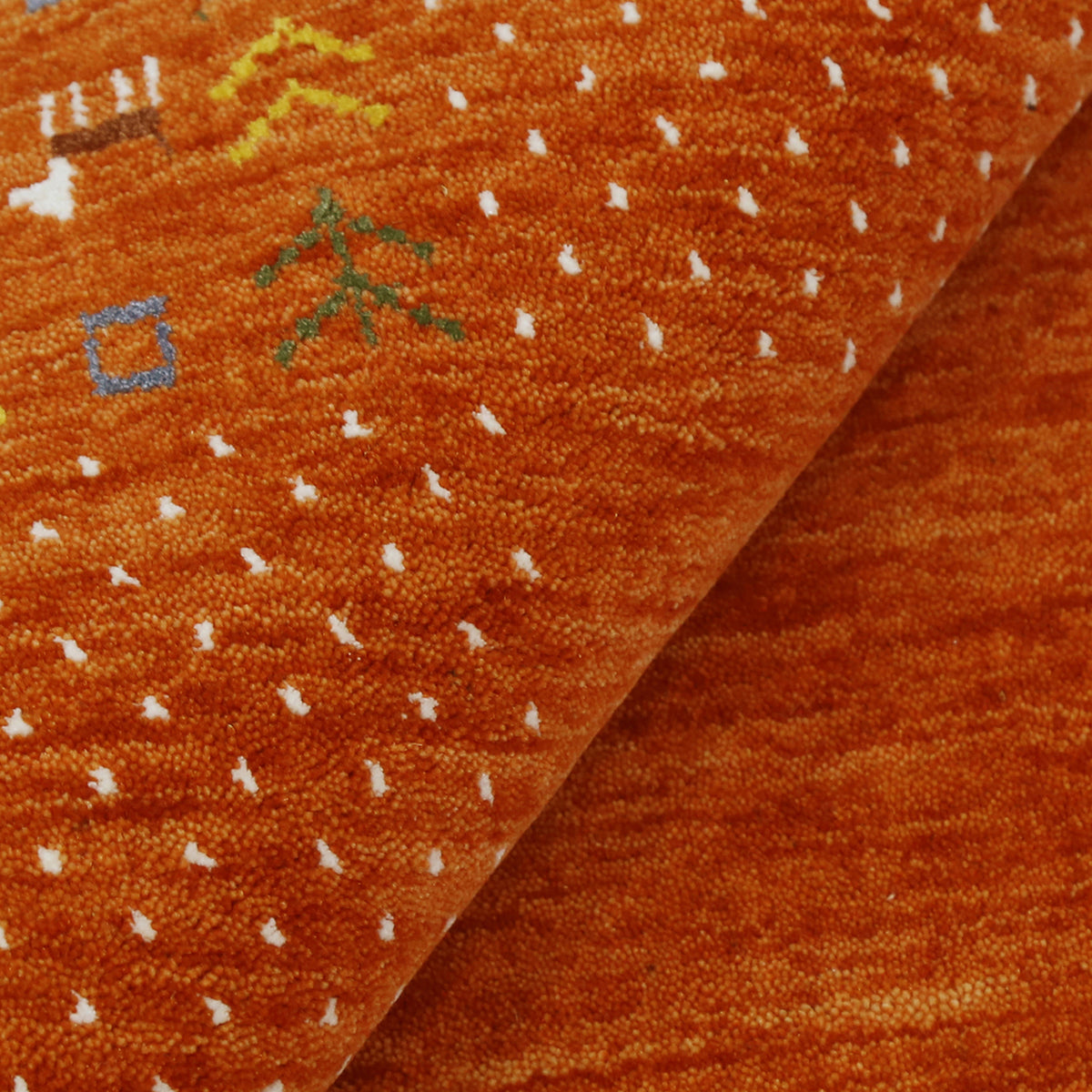 Close-up of terracotta orange Hand Woven Loom Lori wool rug showing natural wool texture, dotted detailing and multicolour tribal motifs