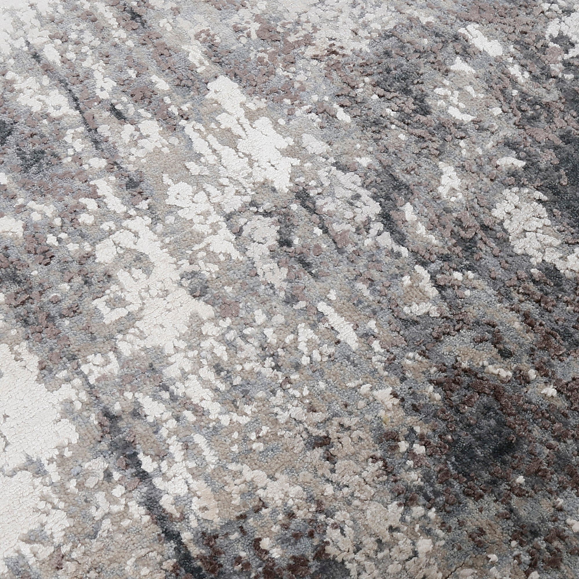 Close-up of the hand knotted wool and viscose texture with silver grey ivory and charcoal abstract detailing