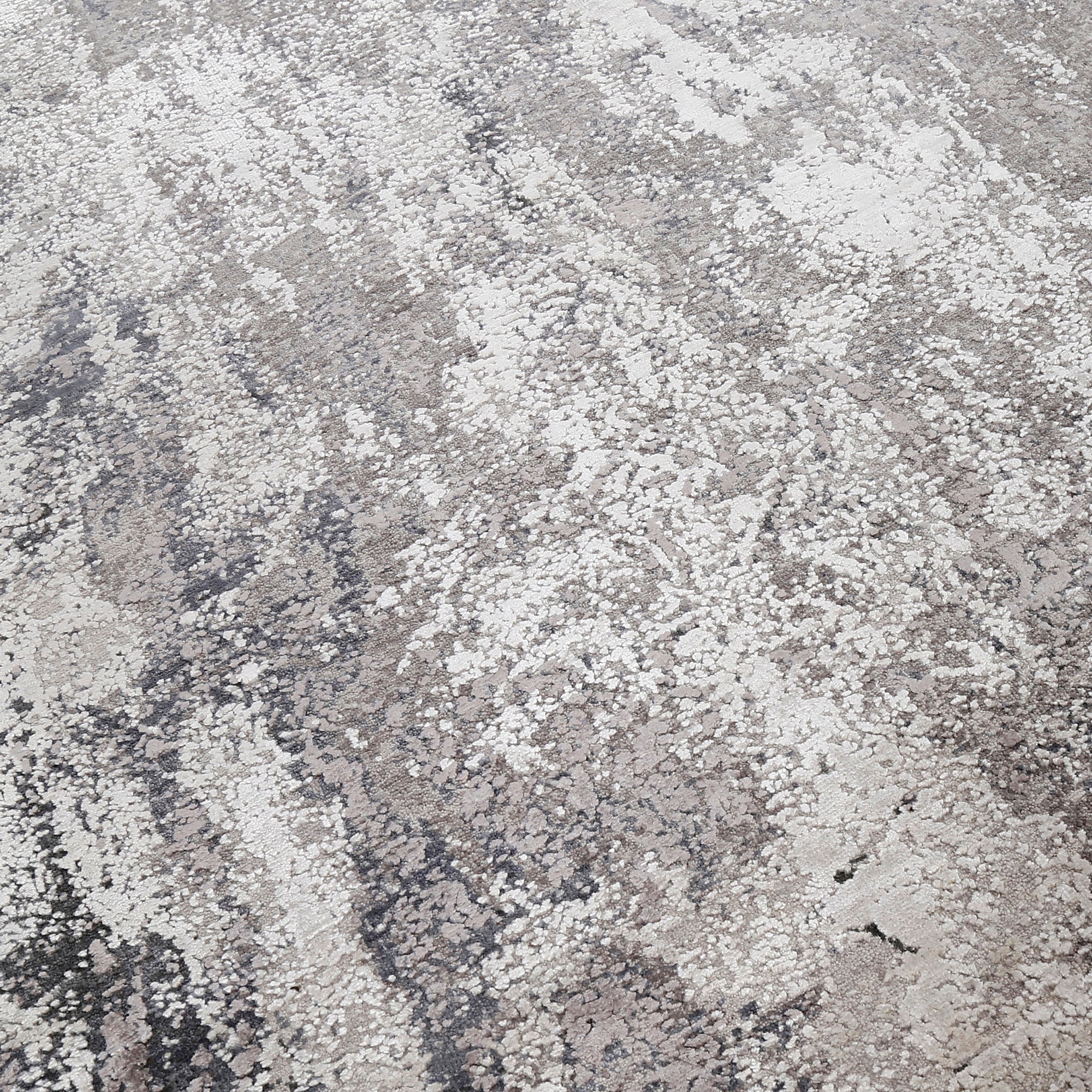 Close-up of the hand knotted wool and viscose texture with grey ivory and slate blue abstract detailing