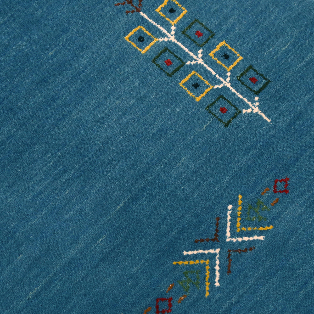 Close-up of sky blue Hand Woven Loom Lori wool rug showing central medallion, symbolic motifs and wool texture