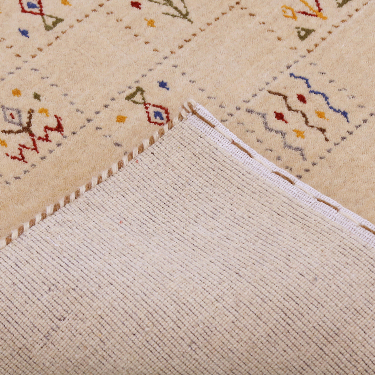 Corner and edge detail of warm beige Hand Woven Loom Lori wool rug showing natural wool texture and handcrafted finishing