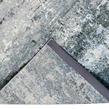 Hand-finished edge and horizontally distressed surface of the Arctic Drift hand knotted modern rug