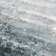 Close-up of the hand knotted wool and viscose texture with silver grey ivory and icy blue abstract detailing