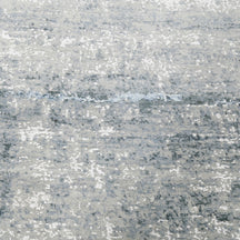 Close-up of the hand knotted wool and viscose texture with silver grey ivory and icy blue abstract detailing