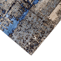 Hand-finished edge and textured abstract surface of the Azure Terrain hand knotted modern rug
