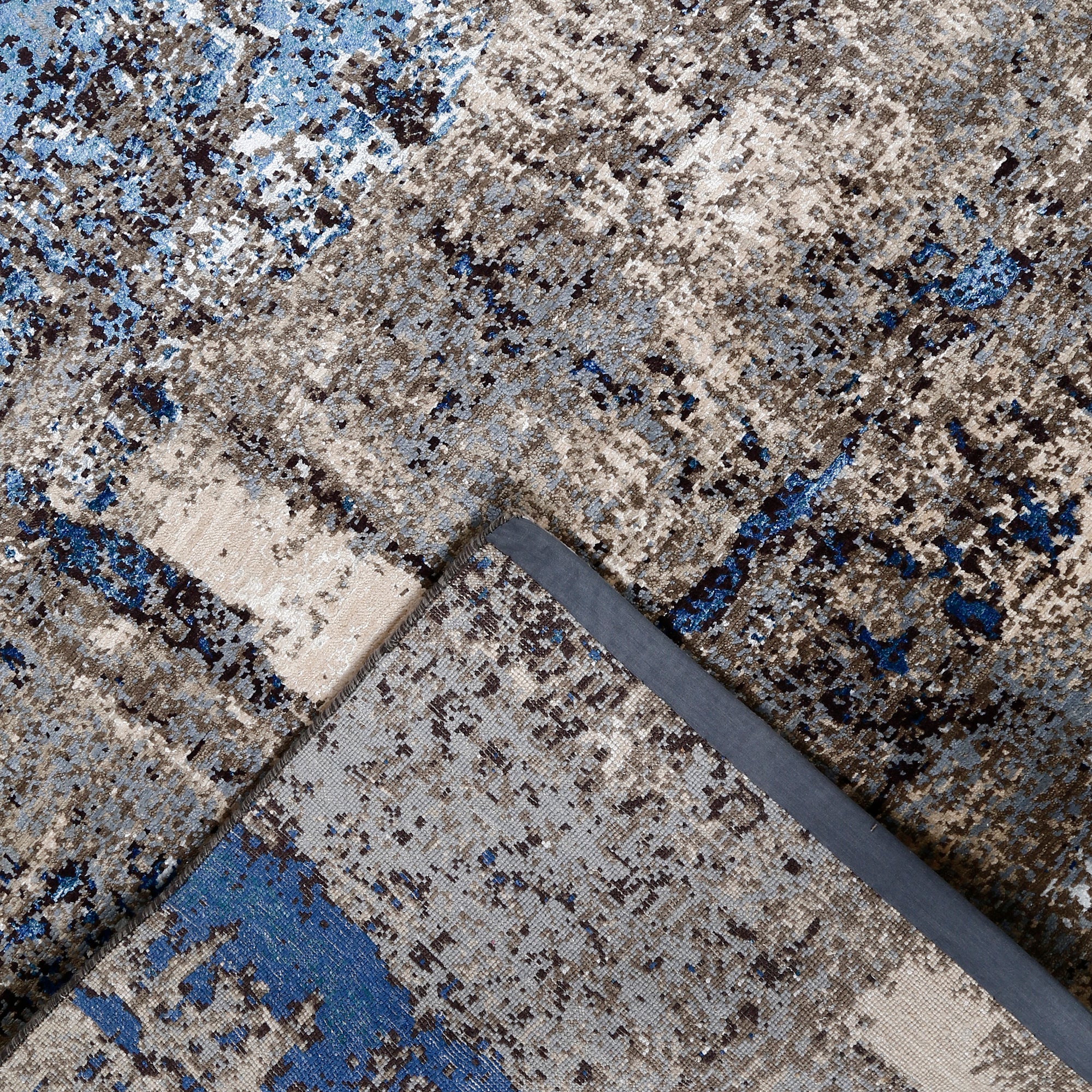 Hand-finished edge and textured abstract surface of the Azure Terrain hand knotted modern rug
