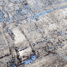 Close-up of the hand knotted wool and viscose texture with beige grey brown and sky blue abstract detailing