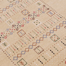 Close-up texture of beige Hand Woven Loom Lori wool rug showing natural wool fibres and detailed tribal motifs