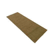 Angled view of Beige Loom Lori wool runner rug highlighting its slim runner proportion, plain design and earthy neutral colour.