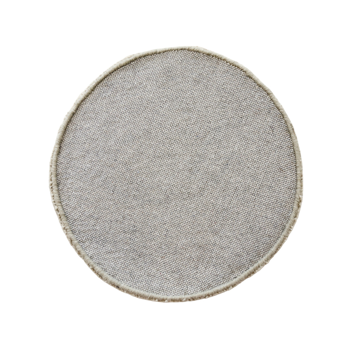 Side angle view of beige smiley face wool kids rug showing its plush hand tufted pile, round shape and playful cartoon design.