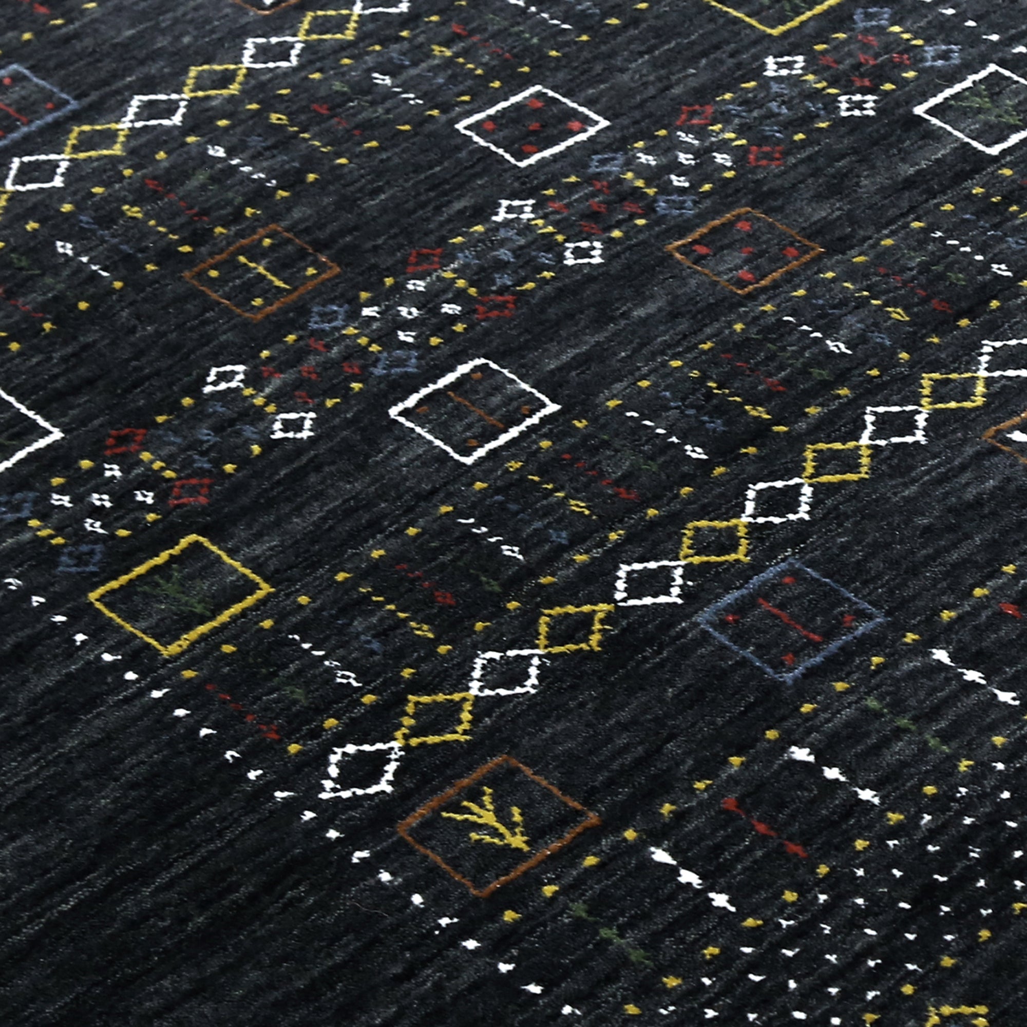 Close-up texture of black Hand Woven Loom Lori wool rug showing natural wool fibres and intricate tribal motif details