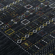 Close-up texture of black Hand Woven Loom Lori wool rug showing natural wool fibres and intricate tribal motif details