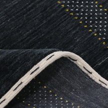 Close-up texture of black Hand Woven Loom Lori wool rug showing natural wool fibres and intricate tribal motif details