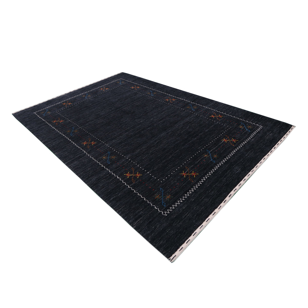 Side angle view of black Hand Woven Loom Lori wool rug highlighting natural wool texture, minimal floral pattern and handmade finish