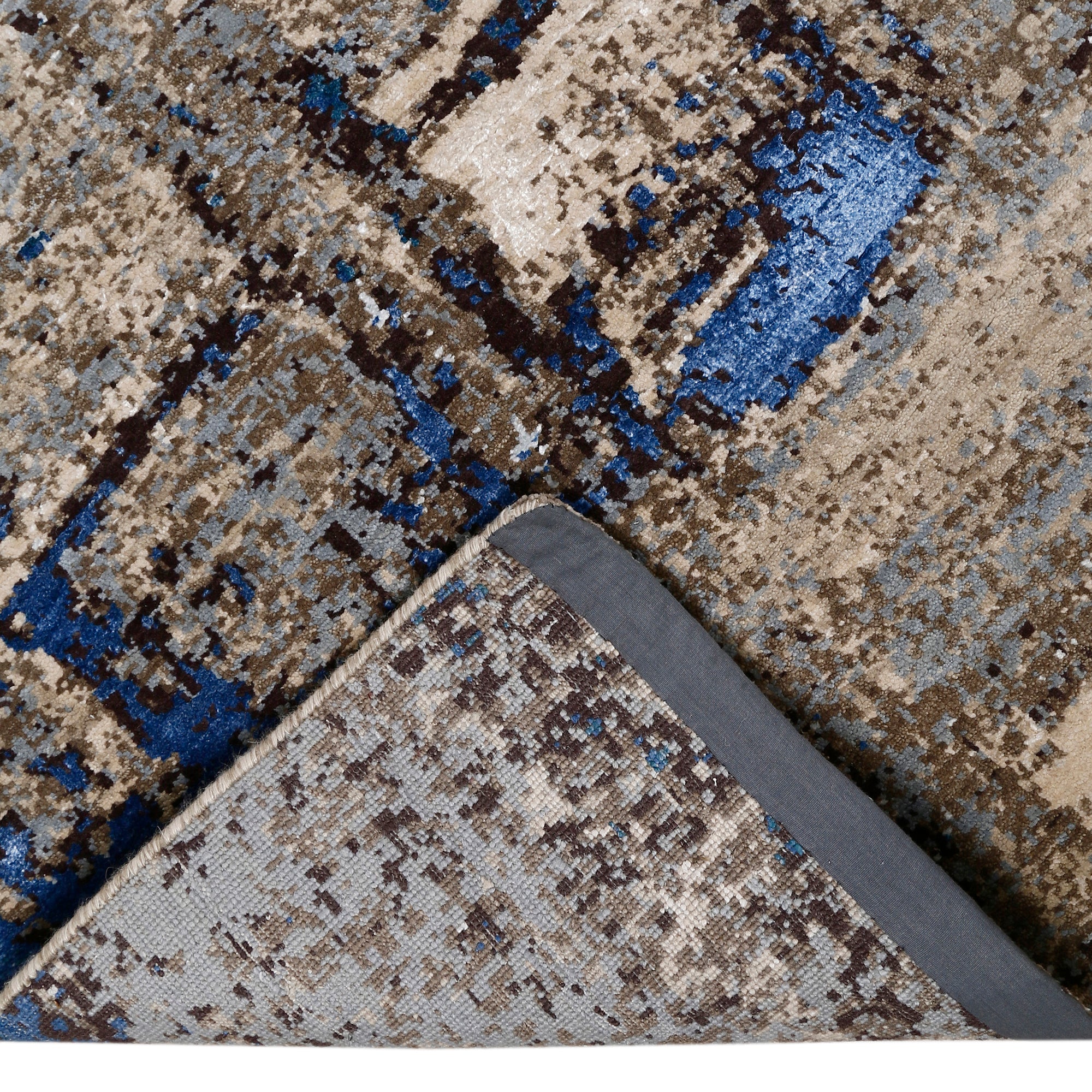 Hand-finished edge and layered distressed surface of the Blue Slate Terrain hand knotted modern rug