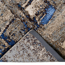Hand-finished edge and layered distressed surface of the Blue Slate Terrain hand knotted modern rug